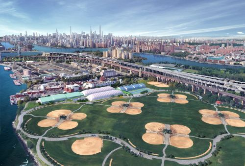 an overhead view of a sports park and the city skyline
