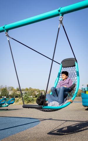 a child reclines in a swing
