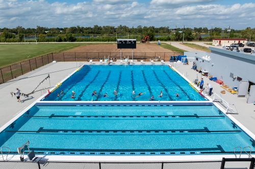 an overview of a swimming pool with swimmers