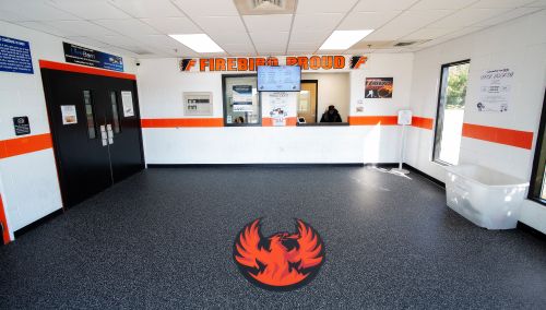 the entry to a skating rink, showing a surface with a phoenix logo