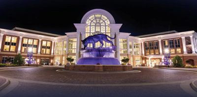 a fountain in front of an arena at night