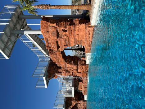 a rock arch diving platform at a pool