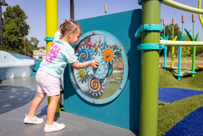 a child plays at a play panel