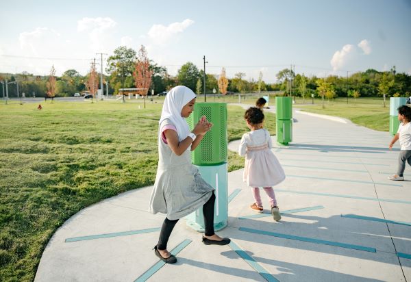 children play around an interactive bollard