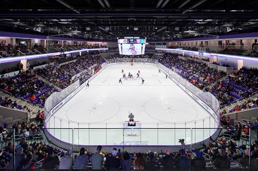 a hockey game in progress with arena seating visible