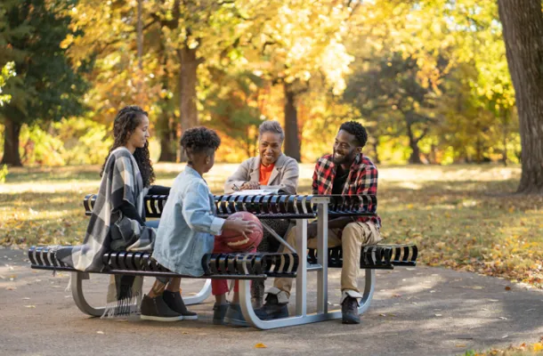 Family Sitting at Table in Park